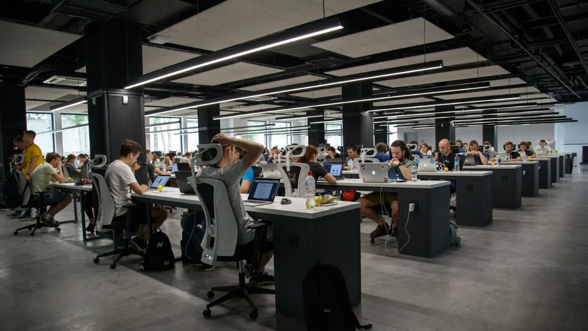 A room full of employees working at their desks.