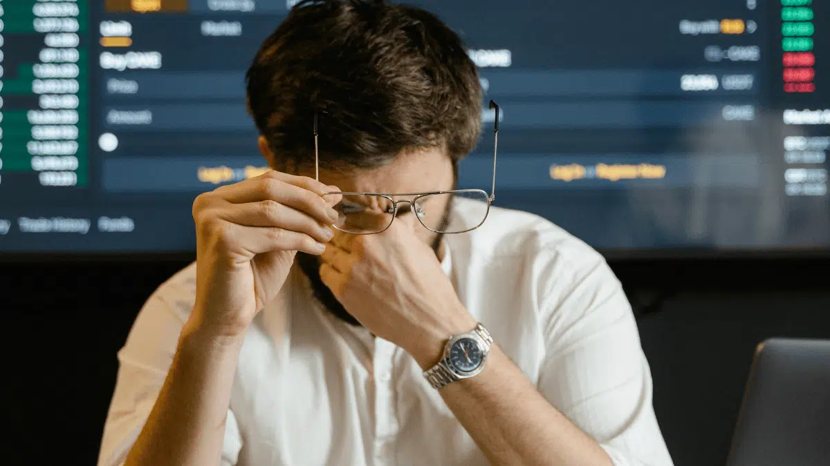 Public sector official looking fatigued as he analyzes data